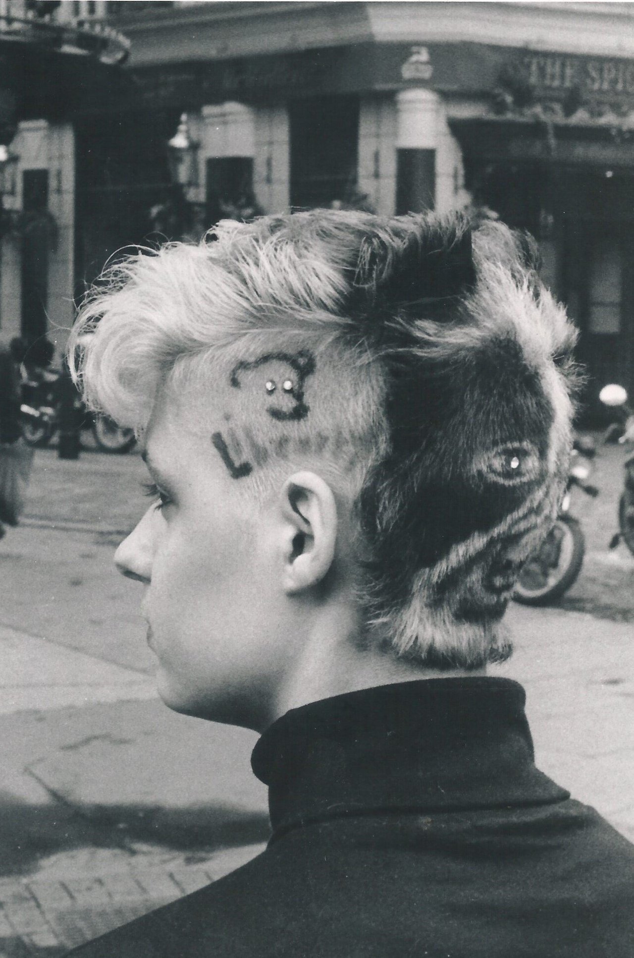 A women showing her hair with the libearty bear campaign logo